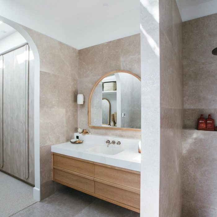 A floating vanity in solid timber with thick white stone detail