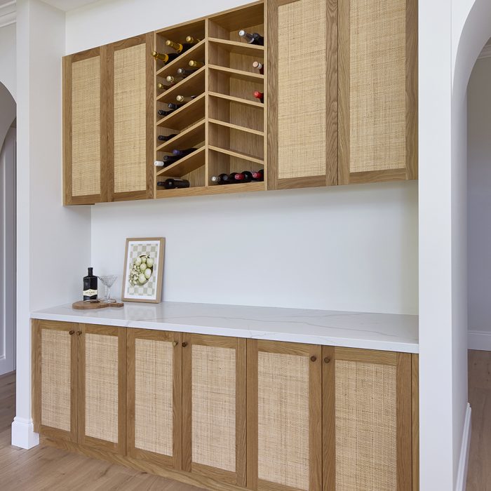 Custom bar area, open wine rack & shaker style door with tight weave rattan