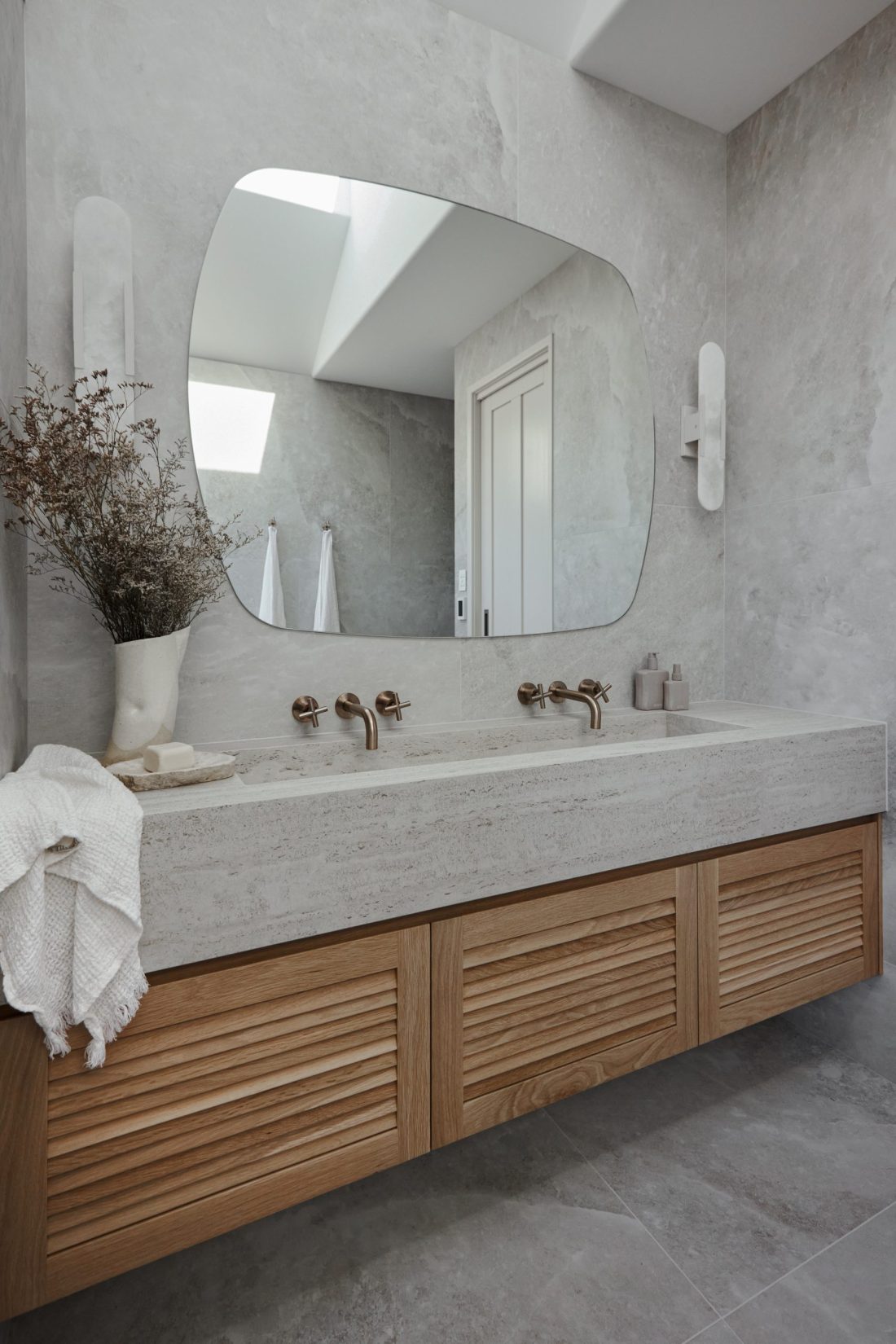 A timber bathroom vanity with a washplane